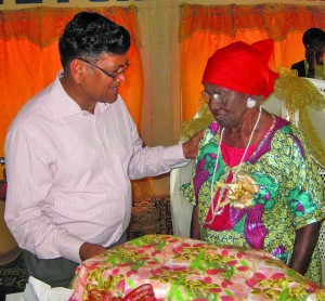 Vice Chairman Bhupaul Jagroop hands over a present to Caroline Benn