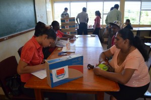 OLPF staff members assist with the distribution of laptops at the Hope Secondary School in Guyana