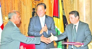 Agriculture Minister, Dr Leslie Ramsammy (left) and Panama’s Agriculture Minister, Dr Esteban Giron, congratulate each other in the presence of President Juan Carlos Varela after signing the agreement     