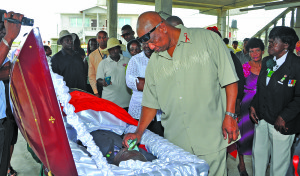 The grieving father of the dead man pays his respects to his fallen son at his home 