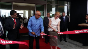 President Donald Ramotar cuts the ribbon to officially declare open the Guyana Marriott Hotel in the presence of Minister of Finance Dr Ashni Singh and other officials. 