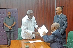 Former Transport and Hydraulics Minister Robeson Benn receiving his appointment letter from President David Granger 