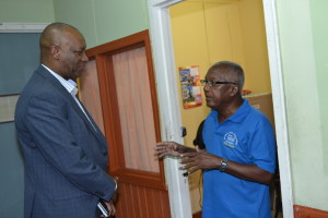 Minister of State, Joseph Harmon interacts with Godfrey Proctor of the National Data Management Authority