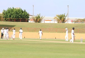 Spinner Veerasammy Permaul celebrates the final wicket, as last man Marlon Richards prepares to walk off (Marceano Narine photo)