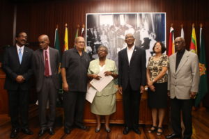 President David Granger and Attorney General Basil Williams (extreme left) with the newly sworn in members of the Advisory Council on the Prerogative of Mercy on  Wednesday at the Ministry of the Presidency 