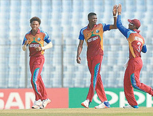 Fast bowler Alzarri Joseph, centre, celebrates a wicket with captain Shimron Hetmyer, right, during the ICC U-19 World Cup. The pair will feature in this year’s CPL tournament. (Photo: courtesy ICC)