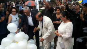 President David Granger and Prime Minister Moses Nagamootoo along with their spouses writing their personal commitments to the promotion of social cohesion on white helium-filled balloons, which were later released up into the sky (Ministry of the Presidency photo)  