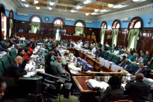 Members of the National Assembly await the arrival of President David Granger