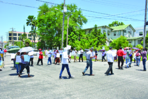 Scores of protesters picketed near GECOM’s building, calling for its Chairman and CEO to be removed