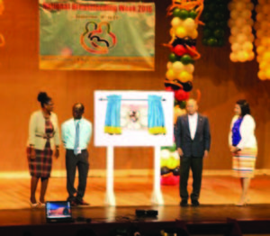 Public Health Minister, Dr George Norton, PAHO/WHO Country Representative, Dr William Adu-Krow and another official after the unveiling of a breastfeeding message at the symposium on breastfeeding