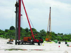 CHEC workers engaged in pile driving recently on the US$150 million CJIA Expansion Project