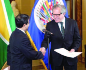 OAS Secretary General Luis Almargo accepting the credentials of Ambassador Riyad Insanally