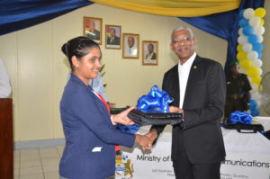 President David Granger presents a Laptop to a trainee teacher during the launch of the One Laptop Per Teacher initiative at Cyril Potter College of Education in Guyana on Wednesday. (Photo by Carl Croker) 