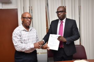 University of Guyana’s Deputy Vice Chancellor, Academic Engagement Dr Michael Scott pose with Project Manager of the CSSP Clement Henry after the signing of the contract for  a survey on the prisons of Guyana  