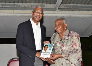 Carmen Jarvis presenting a copy of her autobiography to President David Granger in October 