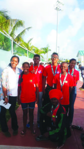Jamaica breast stroke Olympic gold medallist Alia Atkinson (left) strike a pose with back row  from left: Daniel Scott, Alex Winter and chaperone Shonette Winter; middle row are Lian Winter and Leon Seaton Jr while coach Shefetah Tzedeq is stooping  